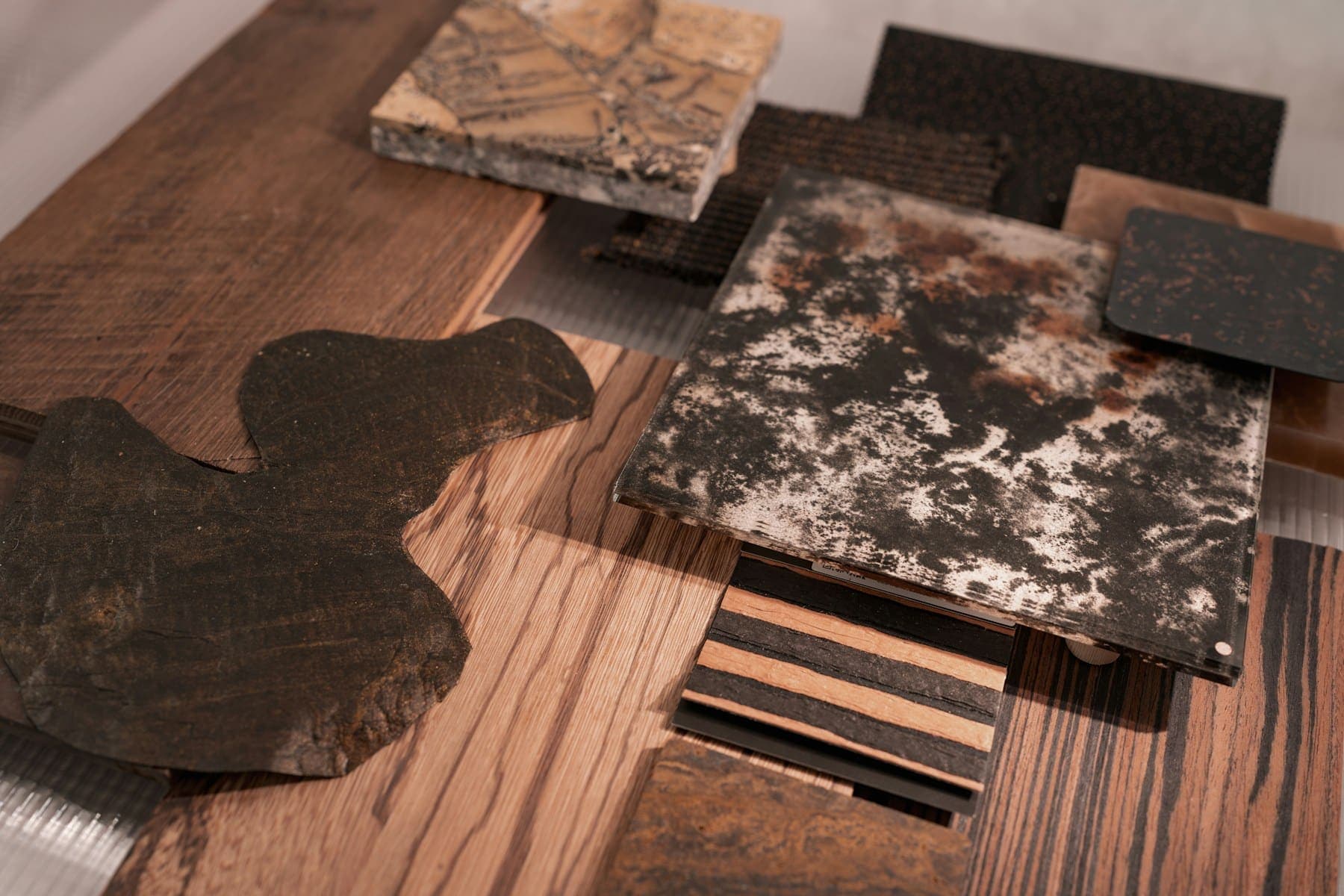 Timber and stone material samples laid out on a table
