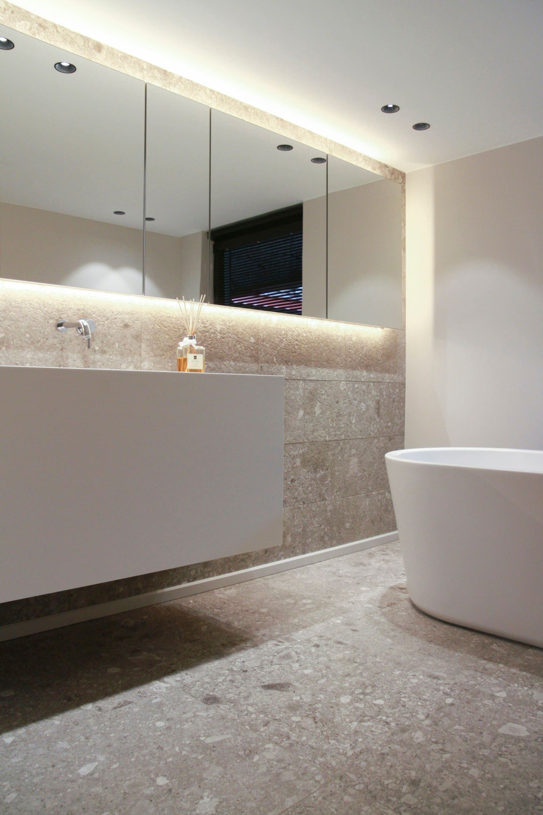 Minimal bath detail with a soft-lit stone ledge