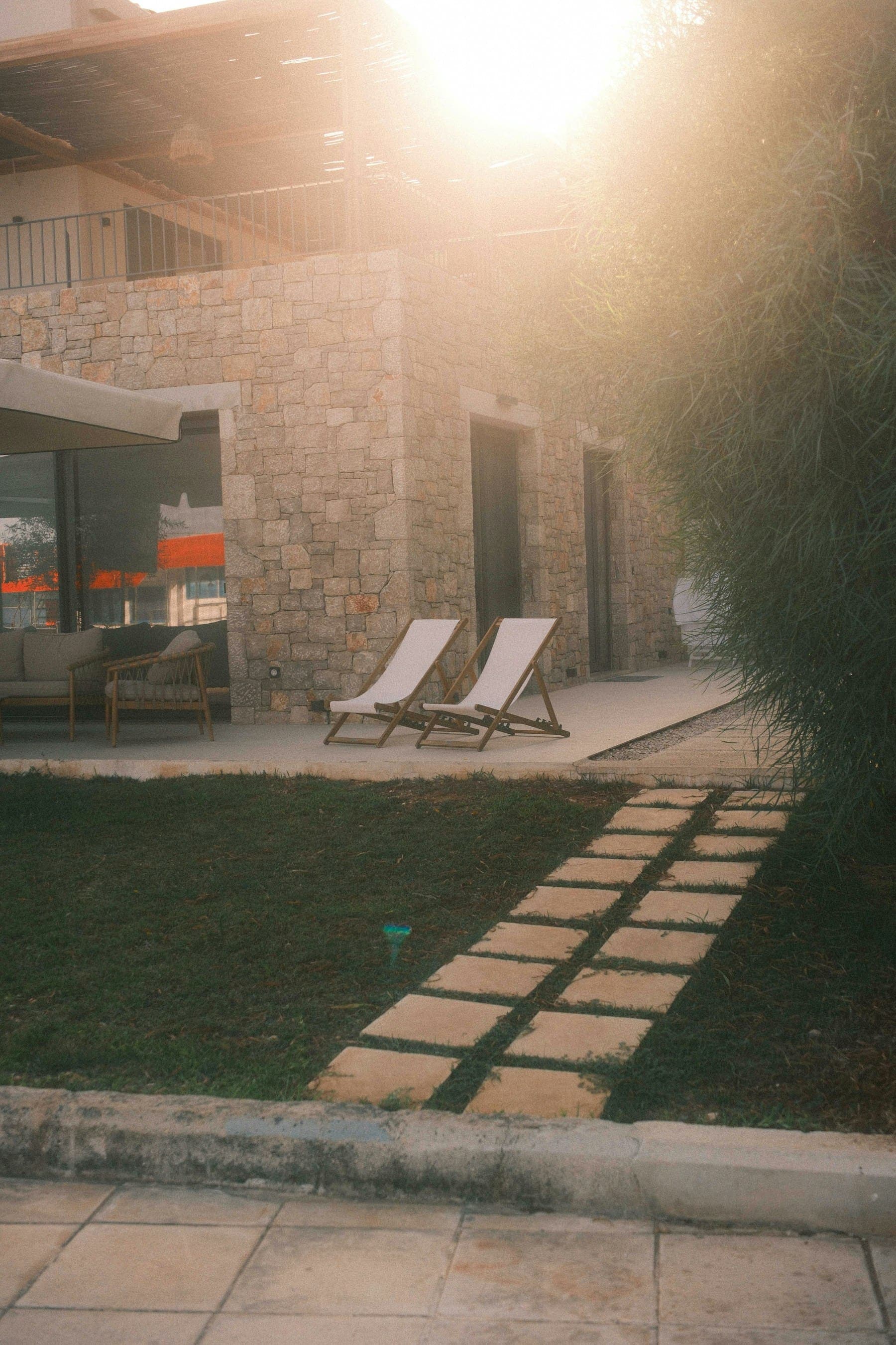 Garden terrace with deck chairs in low evening sun